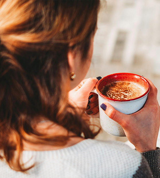 woman holding mug of coffee