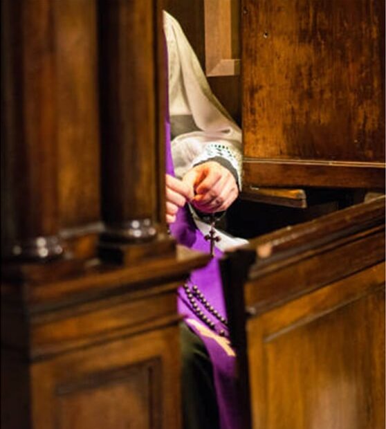 Priest sitting for confession